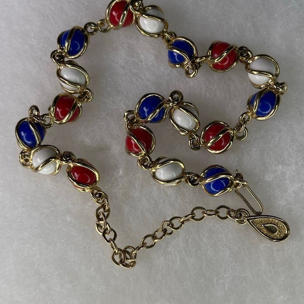 Vintage glass beads wrapped in gold tone cage choker .
